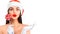 Christmas woman. Joyful model girl in Santa`s hat with lollipop candy pointing hand, proposing product. Surprised expression