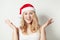 Christmas Woman in Santa Hat Having Fun and hands up. Smiling Xmas Model