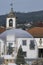 Christmas wooden and pine cabin inside giant transparent bubble with church in the background in Aroucas Portugal