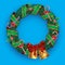 Christmas wreath with bells candy bows mistletoe ribbon pine on blue isolated background. Vector image