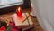 Christmas wreath, books, candle, lantern on window