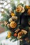 Christmas wreath of Christmas trees, tangerines, oranges and berries on a background of Christmas lights