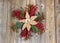 Christmas wreath with cloth flower on rustic wooden boards