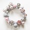 Christmas wreath of decor, silver and pink balls, painted vine on white.