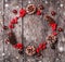 Christmas wreath of Fir branches, cones, red decorations on dark wooden background.