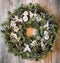 Christmas wreath with frozen pine cones and pines. Advent theme on wooden background