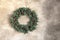 Christmas wreath on gray marble wall