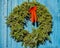 Christmas Wreath Hanging on Blue Wood