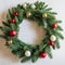 Christmas wreath hanging on white wall, copy space inside it.