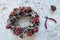 Christmas Wreath Made of branches decorated with gold wooden stars and red berry bubbles. Creative diy craft hobby. Making