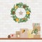 Christmas wreath made with pine, eucalyptus, spruce, pine cone, dry orange. Shelf with present gifts in kraft paper. Eco Christmas