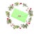 Christmas wreath made of thuja twigs, red wild rose fruits with green envelop and candy cane in the middle. White