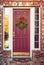 Christmas wreath on red wooden door