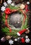 Christmas wreath , snowflakes , red ribbon and various winter decorations on rustic wooden background
