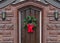 Christmas wreath on wooden front door of brownstone house