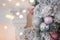 Christmas, xmas, New Year pink and turquoise fur-tree decoration with balls and bowknots, ribbons, flowers on pink lights