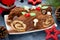 Christmas Yule Log cake decorated with chocolate holly mushrooms