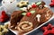 Christmas Yule Log cake decorated with chocolate holly mushrooms