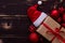 Christmass flatlay gift box,Santa hat and red christmas tree toys on wooden background.