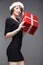 Christmass woman hold gift. Beautiful fashion model