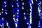 Chritmas blue glitter lights background. Defocused