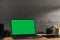 Chroma key green screen, angled view laptop on table with digital photography equipment