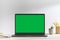 Chroma key green screen laptop on table with white background