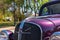 Chrome hood ornament on a vintage purple Chevrolet