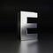Chrome letter E uppercase. 3D render shiny metal font isolated on black background