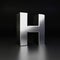 Chrome letter H uppercase. 3D render shiny metal font isolated on black background