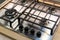 Chrome plate of gas cooker. Four control knobs. Kitchenware.