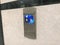 Chrome plated or stainless steel finished Floor indicator panel fixed on a granite finished wall cladding and fixed in between the