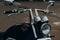 Chromed motorcycle handlebars and headlights, close-up Stylish custom chopper motobike with chrome details. Soft selective focus