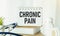 Chronic pain text write on notepad, medical