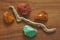 Chrysoprase, carnelian, amber and dry tree. Collection of natural rough stones on a natural wooden background made of black