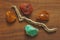 Chrysoprase, carnelian, amber and dry tree. Collection of natural rough stones on a natural wooden background made of black