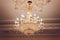 Chrystal chandelier lamp on the ceiling in Dining room Adjusting the image in a Luxury tone .Decorative elegant vintage