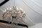 Chrystal chandelier lamp on the ceiling in a wedding tent. Decorative contemporary and elegant vintage  interior concept