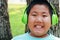 Chubby Asian boy wears music headphones