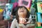 Chubby Asian little girl celebrating her birthday at home. Happy and jovial in front of the cake. Soft focus