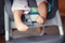 chubby baby legs feet. Small kid sitting in high chair