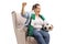 Chubby female soccer fan with a scarf and a football sitting in an armchair and cheering