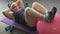 Chubby girl doing press-up exercises using big gymnastic ball at home, workout