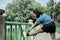 Chubby girl stratching at a bridge