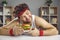 Chubby obese caucasian man in sportswear holding burger on plate portrait