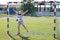 Chubby smiling girl in sportswear stands in football gate and wants to stop ball