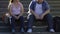 Chubby students talking and smiling, sitting on stairs near university, friends