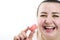 chubby woman eats delicious pink cherry raspberry strawberry macarons laughs on white background sincere laughter