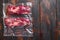 Chuck roll  beef steak Vacuum packed meat on dark old wooden table, top view with space for text