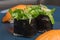 Chukka gunkan seaweed sushi and rolls on a blue plate. Serving Japanese food